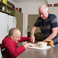 Friends making food in the kitchen together.