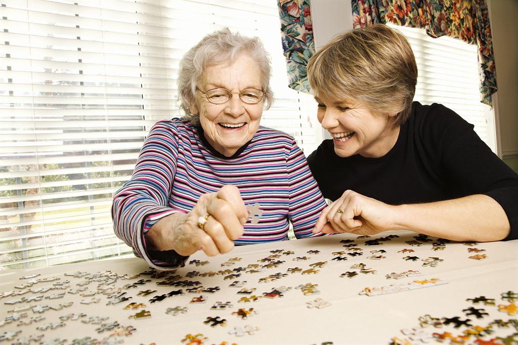 A young girl gardening with an elderly woman